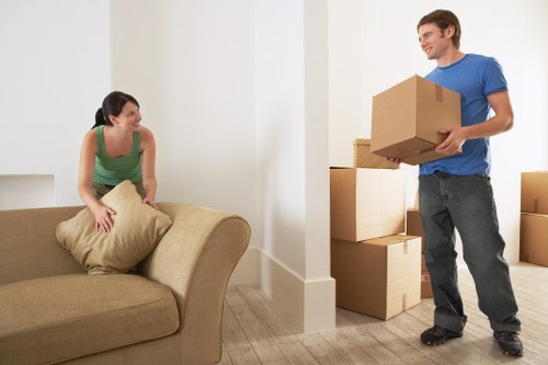 Staff using PPE while handling furniture during a house move